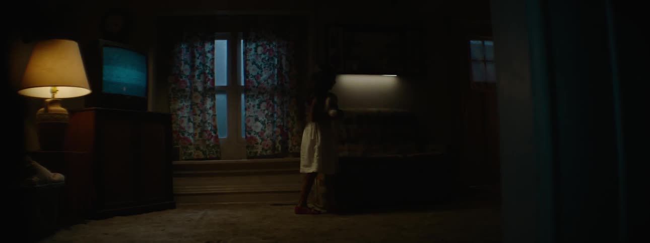 Child walking in a dark living room