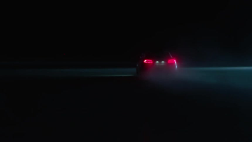 Sports car driving fast in the dark night