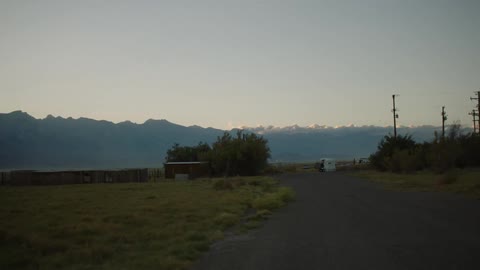 A rural area is shown with mountains in the distance