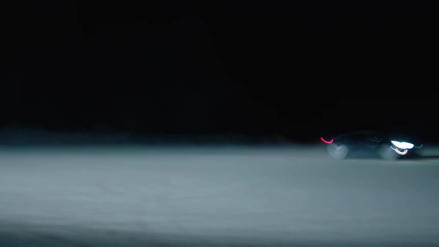 A car drives in circles at night