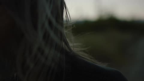 A man's hair blows in the wind