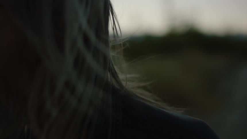 A man's hair blows in the wind