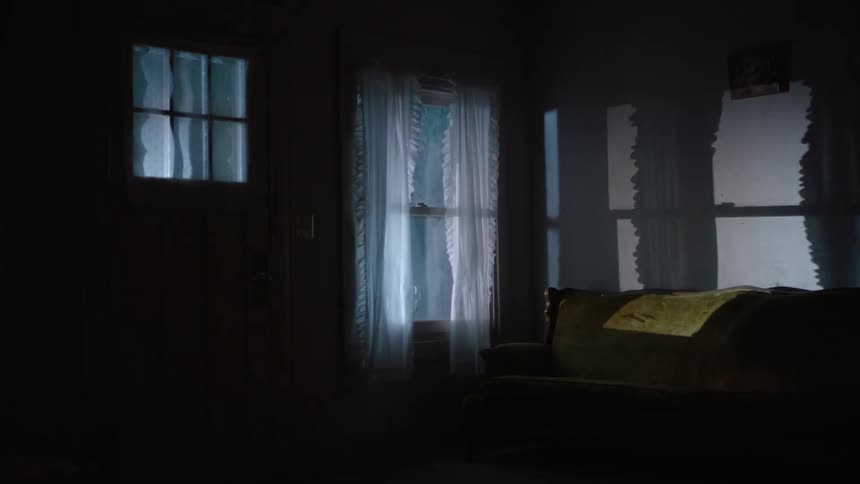 A view from inside a house and lights flashing outside