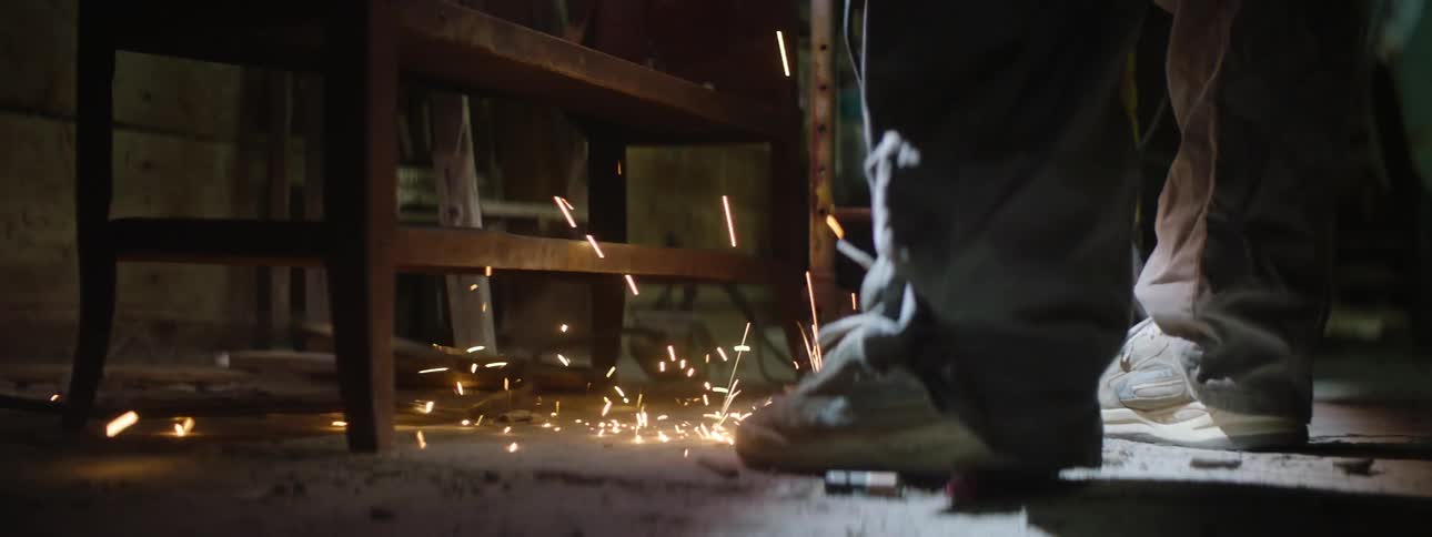 Sparks fly onto the floor of a shop