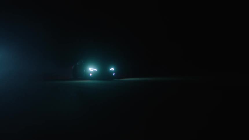 Car driving on pavement at night