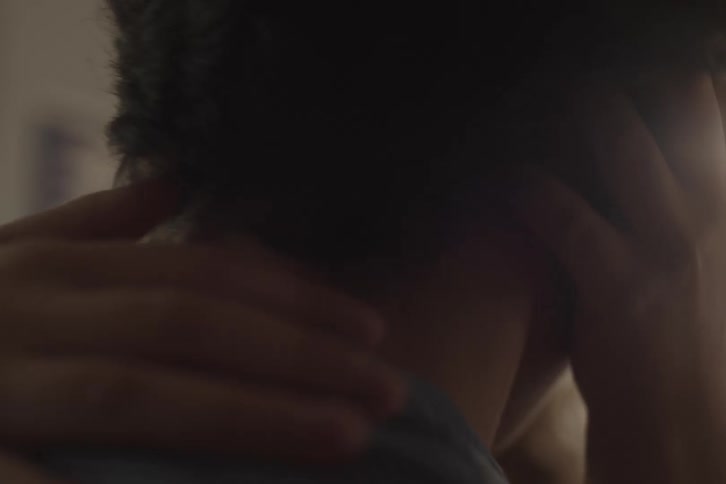 Hand holding someones neck in a gesture of affection