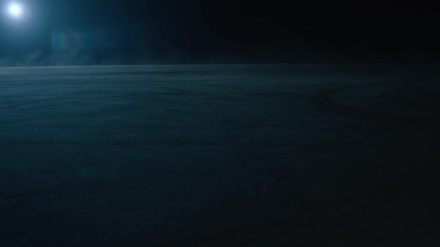 A car driving in circles at night with a full moon in the sky