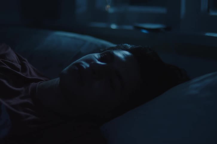 The teenager is sleeping in bed
