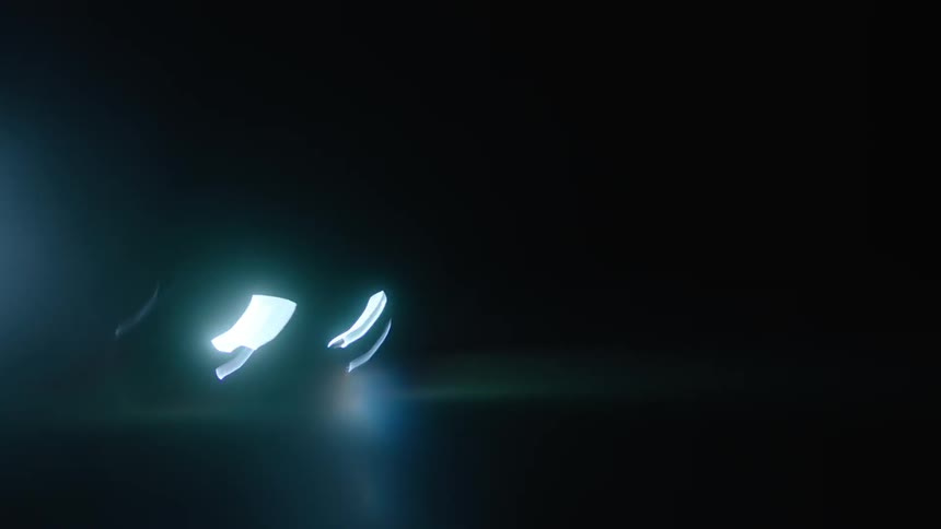 A car drives at night with its headlights on