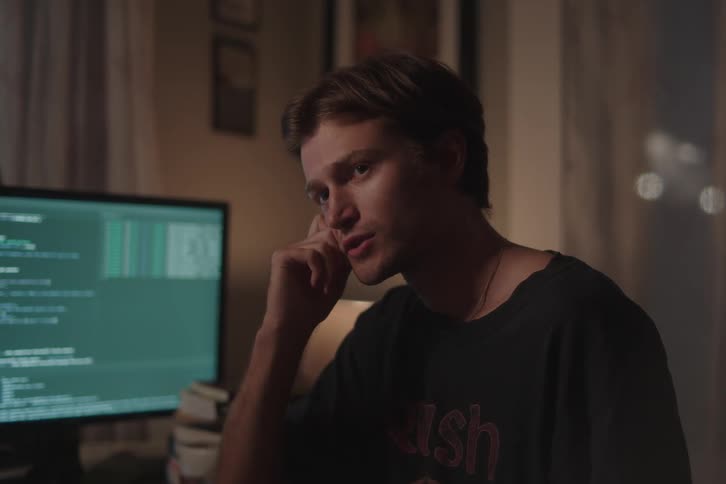 Man analyzing code on a monitor at night