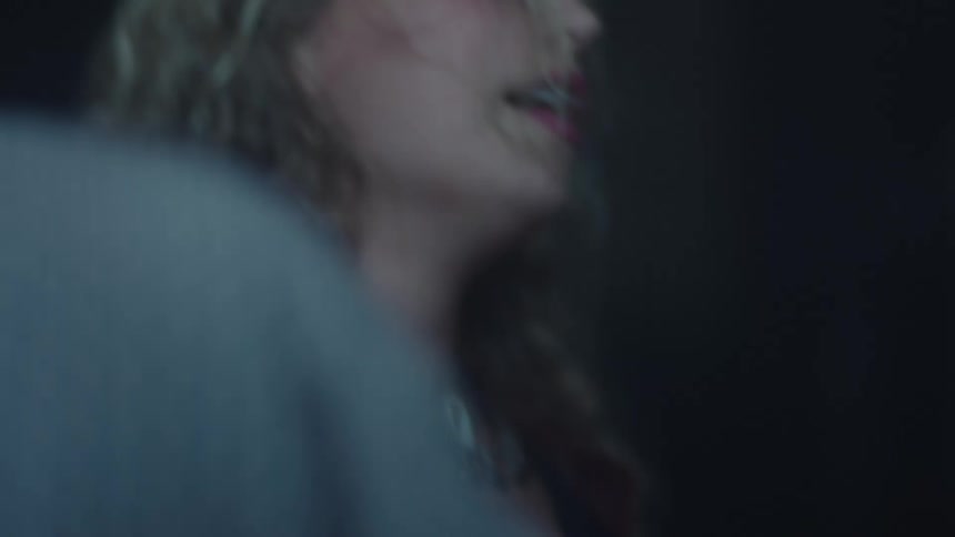 Blonde young woman in red clothes dancing at a night club indoors