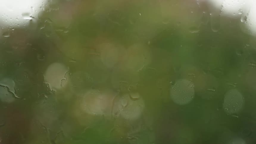 Windshield wipers move across the windshield during rainfall