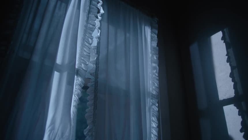 Light shines through white curtains