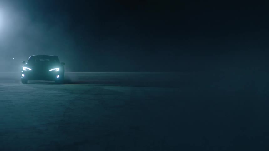 A car swerves through a dark parking lot