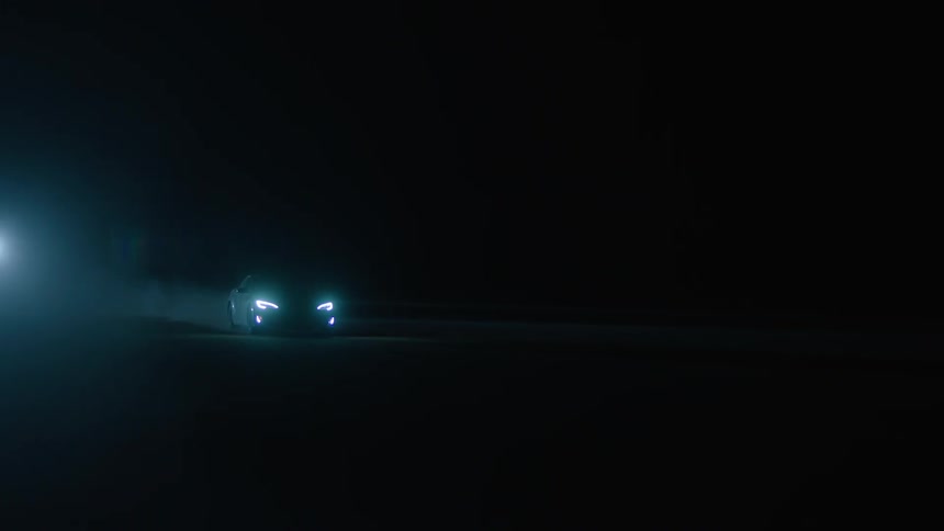 Car driving on pavement at night