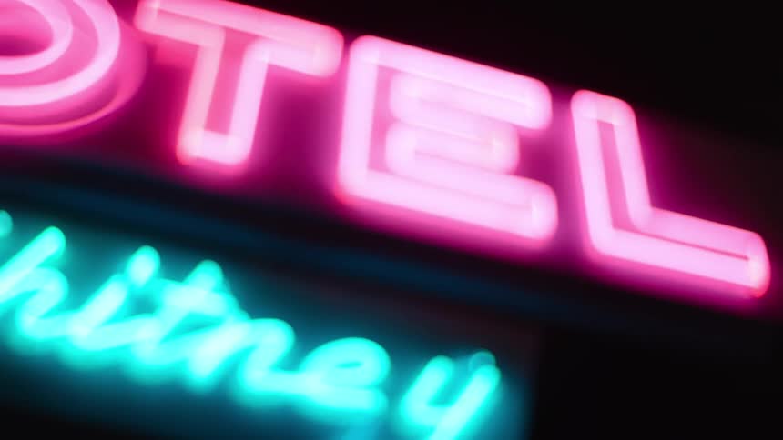 A motel sign is illuminated at night