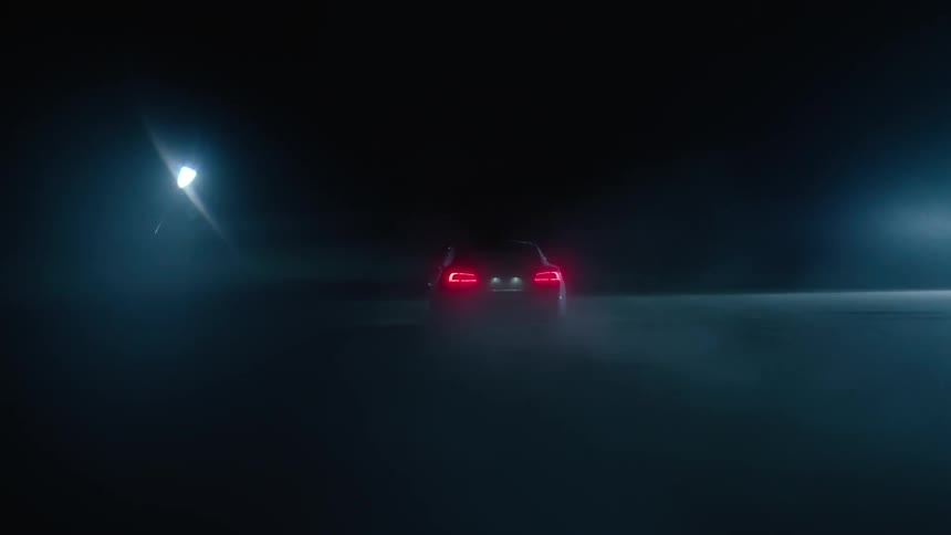 Car rear lights shine as it speeds at night