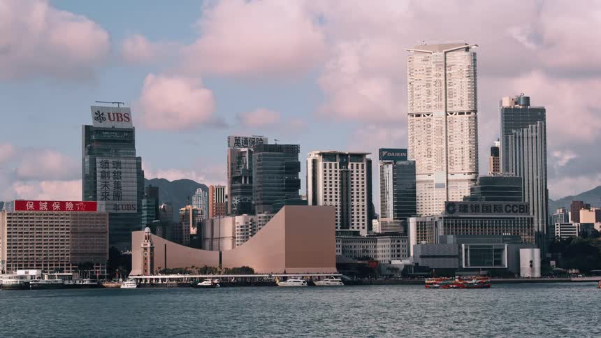 Urban skyline of hong kong with waterfront skyscrapers under a partly cloudy sky