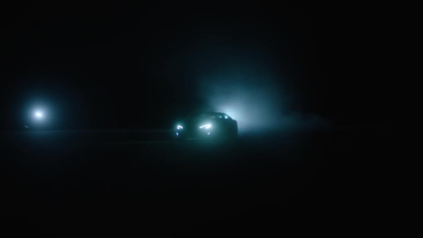 Car driving on pavement at night