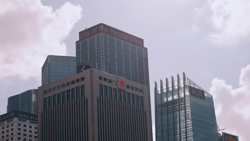 A sunny day reveals a city skyline filled with towering highrise buildings