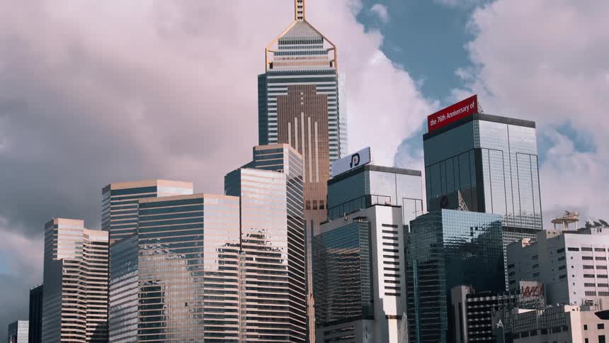 Cluster of mirrored skyscrapers in hong kong illuminated by sunlight