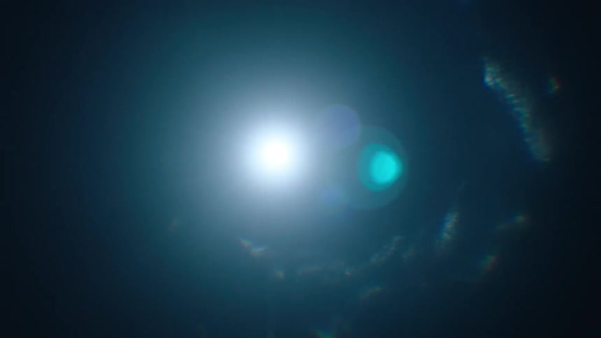 A bright light shines through darkness