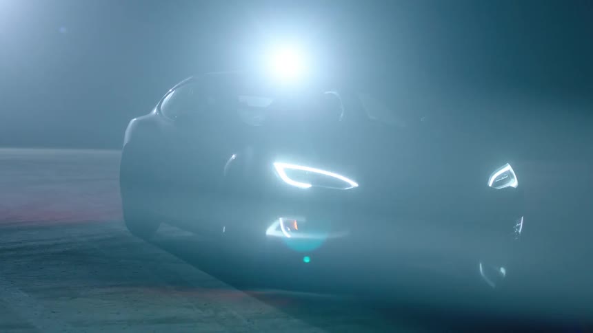 A car is parked at night with its headlights on