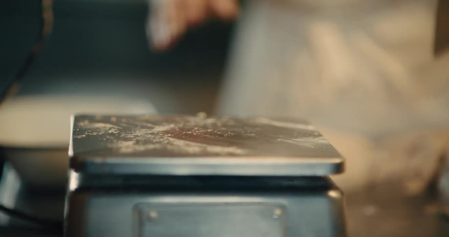 Dough is taken off metal scales in a bakery