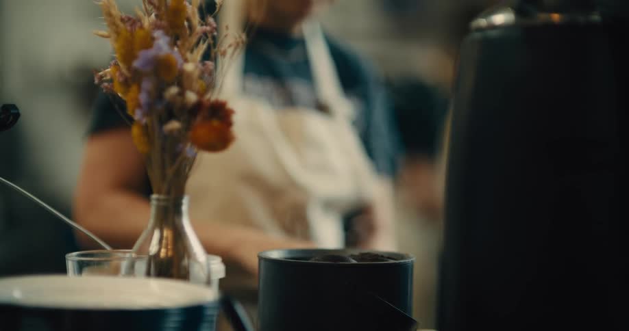 Arrangement of dried flowers in a vase on the counter of an artisan bakery