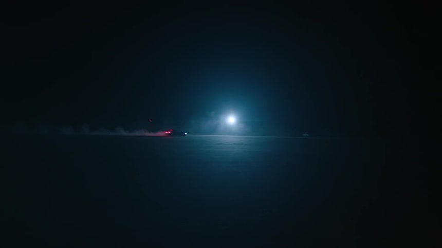 Car driving on pavement at night