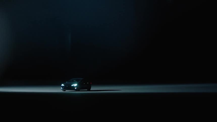 Car driving on pavement at night