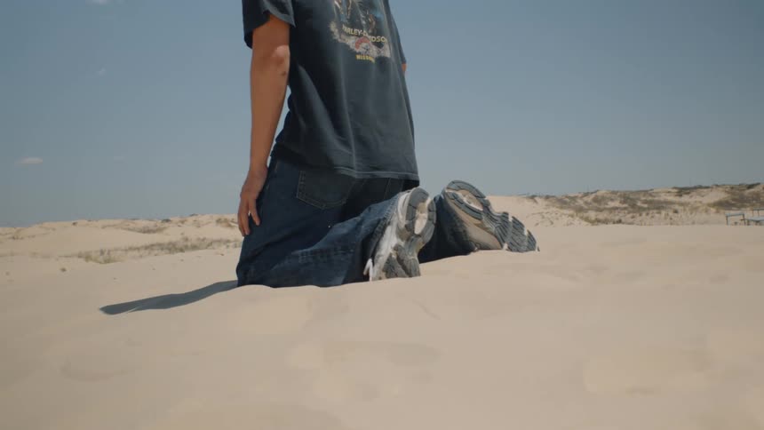 Man walking on a deserted area and falling on his knees outdoors during day time