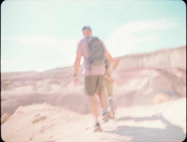 A couple hike along a desert
