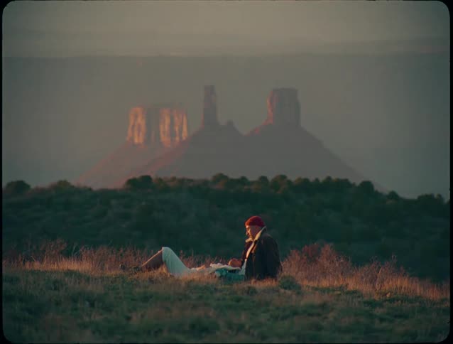 Man and woman sit together on the field