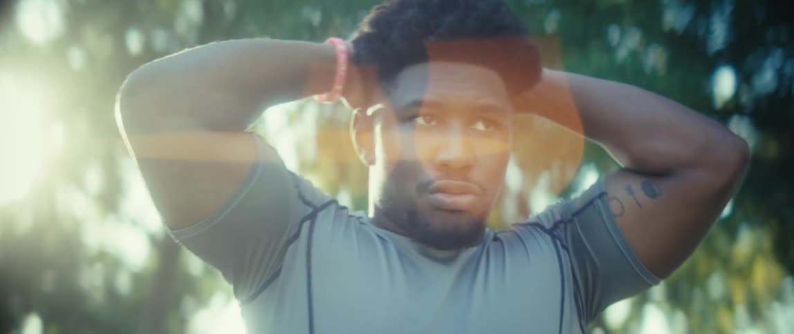 Black man puffing and sweating outdoors during day time