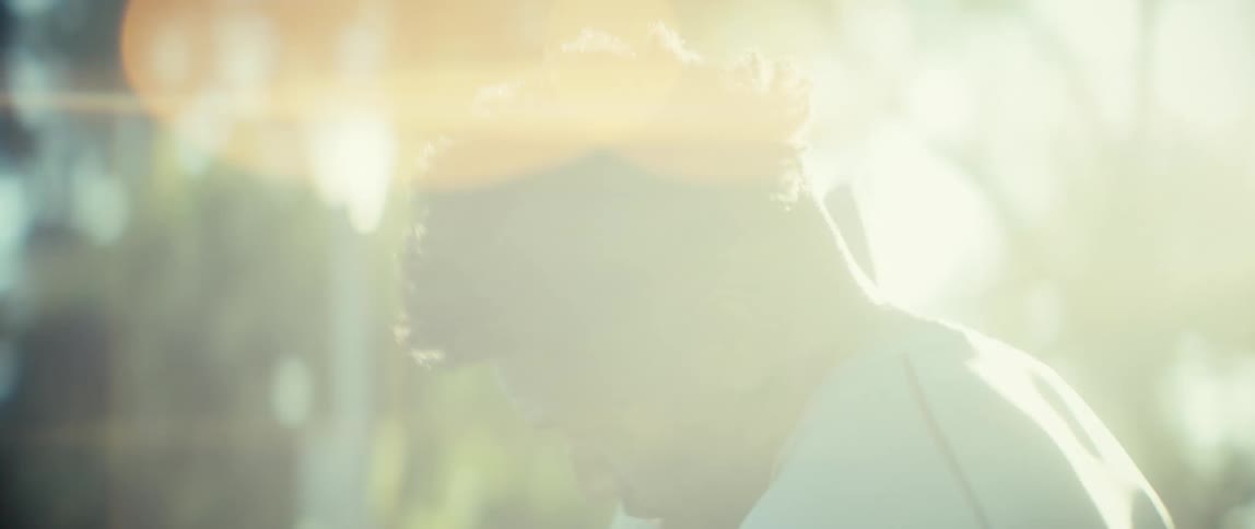 The man wipes sweat from his face
