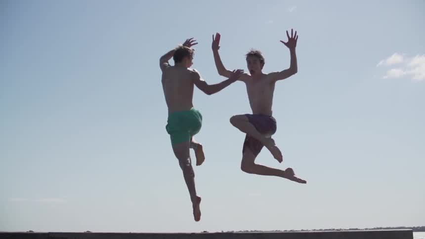 Two men running and jumping into the air