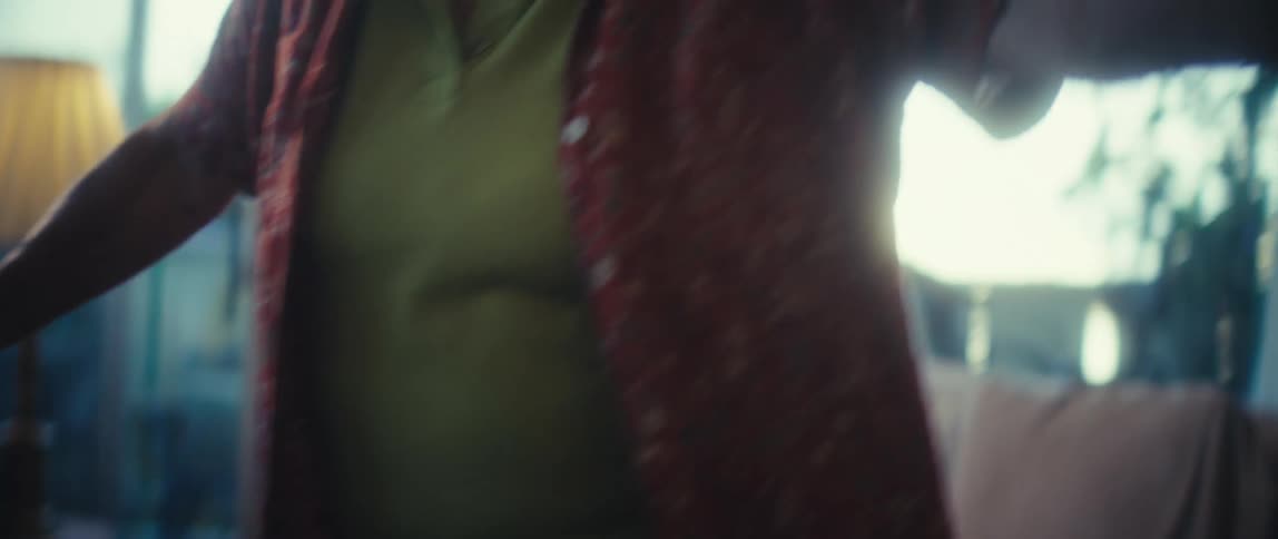 An elderly woman dances alone on her rug in the living room at midday excited