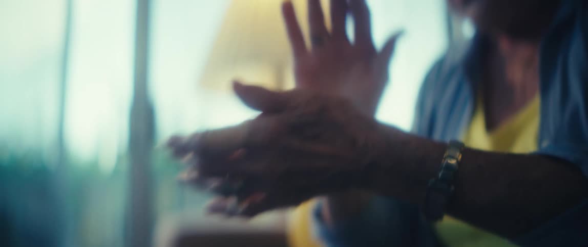 Blurred hands of a person gesturing in a welllit environment