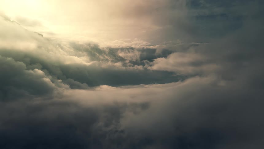 Drone flies through heaven, surrounded by soft sunlight and clouds