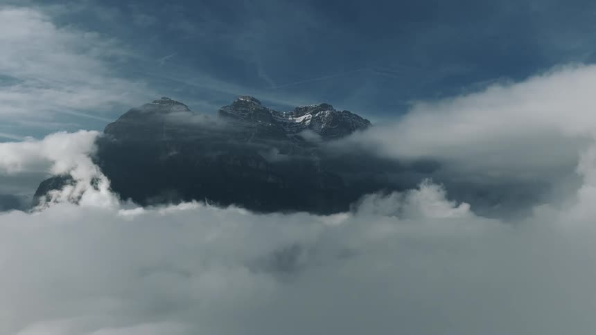 Clouds touch the peak of the mountain
