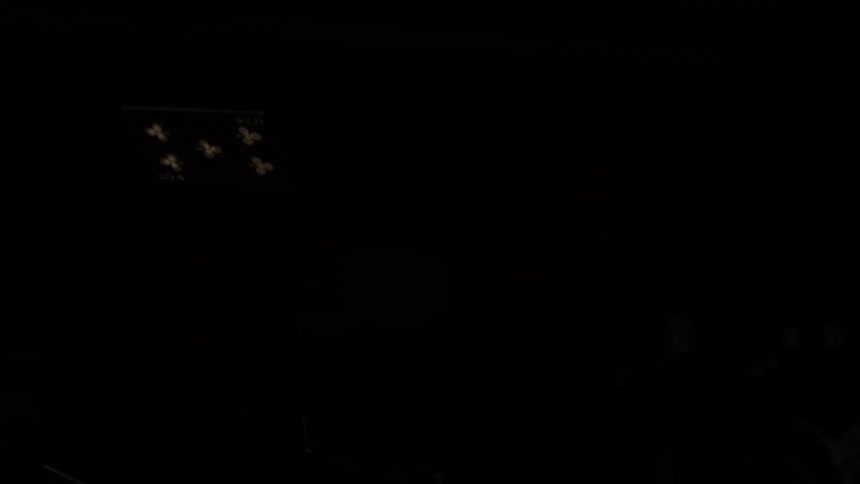 Playing cards falling in the dark with visible golden symbols