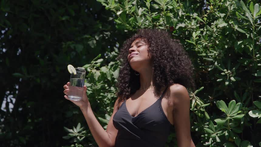 The video clip shows an overhead closeup shot of a persons legs and feet standing on a light slightly reflective floor the person appears to be wearing black slacks and brown leather dress shoes