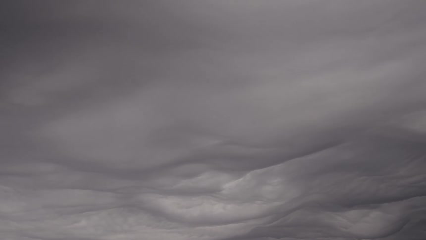 Thick wavy clouds covering the sky in shades of gray