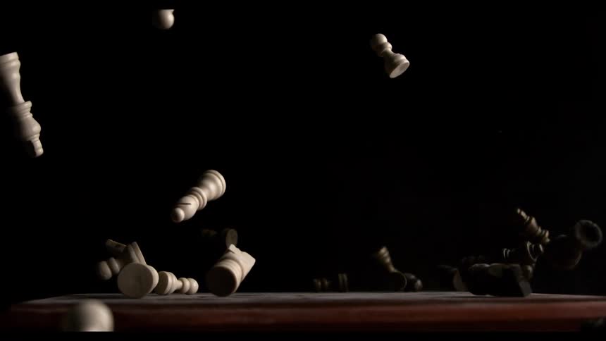 Chess pieces on a falling chessboard fly into the air when the chessboard lands on a flat surface