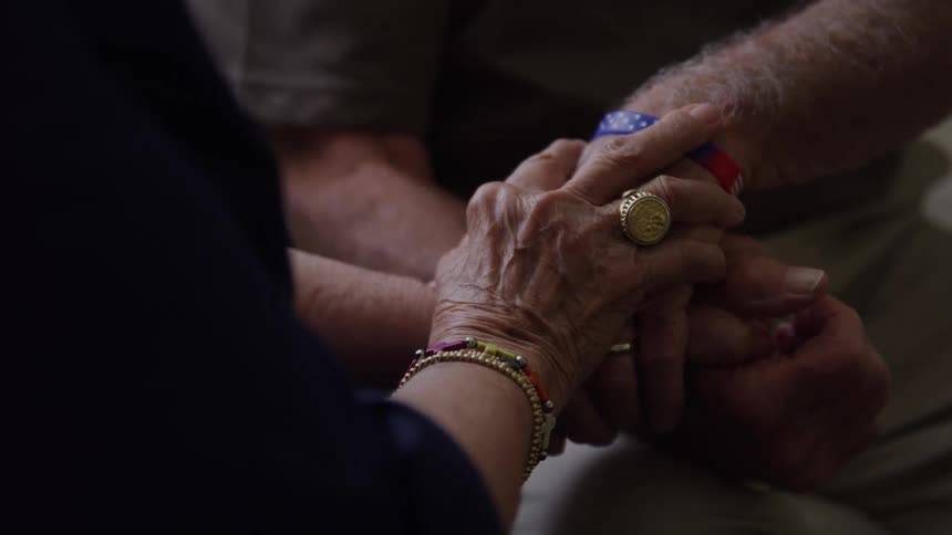 Elderly couples hands intertwined in a gesture of affection and support