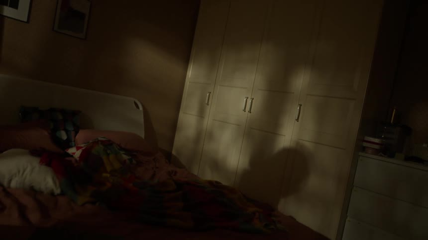 Woman dances in her bedroom while holding a jar of nut butter