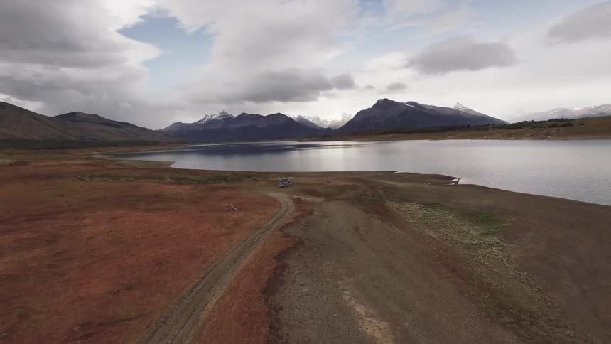 A view of a lake in the middle of nowhere surrounded by mountains