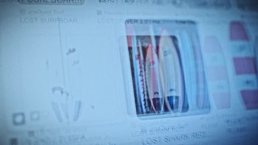 A computer screen shows a grid of image search results with small surfboard thumbnails viewed in a cool blue tint
