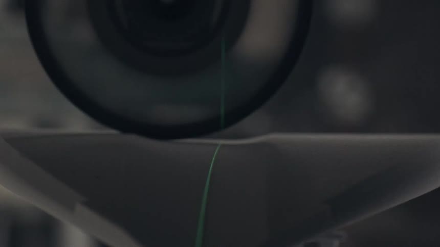 Green laser crosses surfboard surface